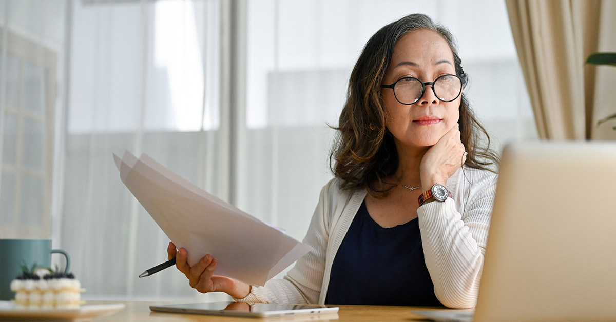 Woman looking at computer pondering