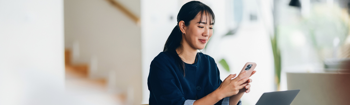 Smiling young professional woman in business attire, projecting confidence and positivity in a corporate environment.