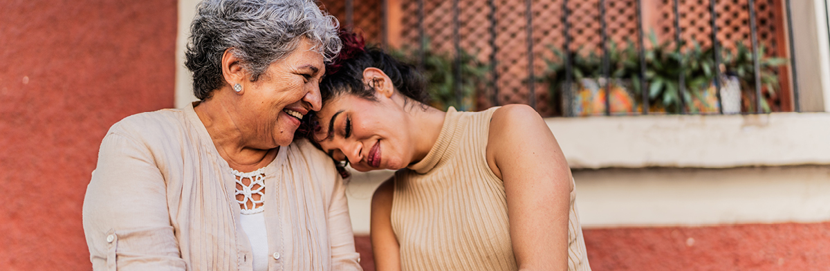 A woman and an older woman embrace warmly, showcasing a moment of love and connection between generations.