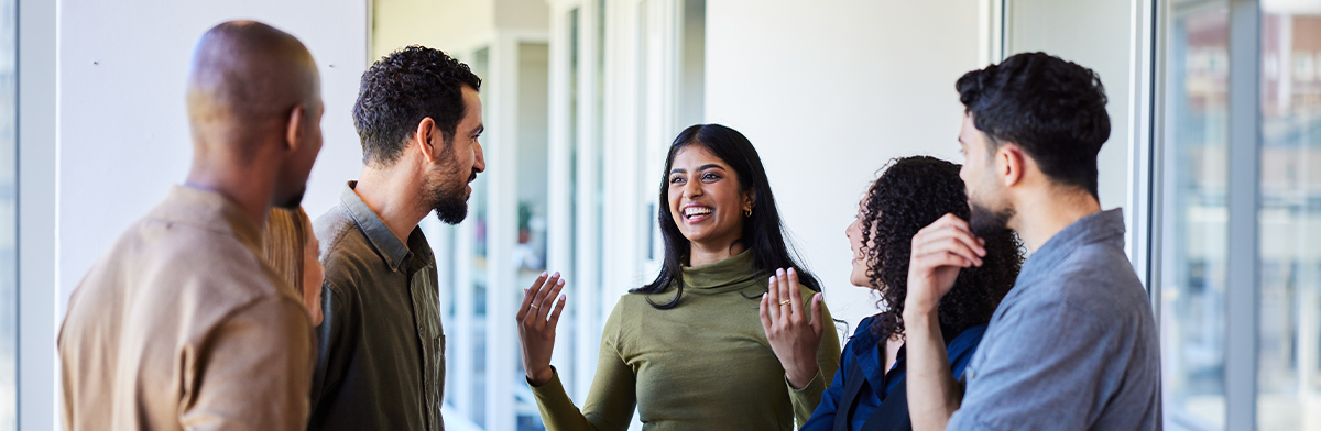 A young professional couple discusses business strategies, showcasing collaboration and teamwork in a professional setting.