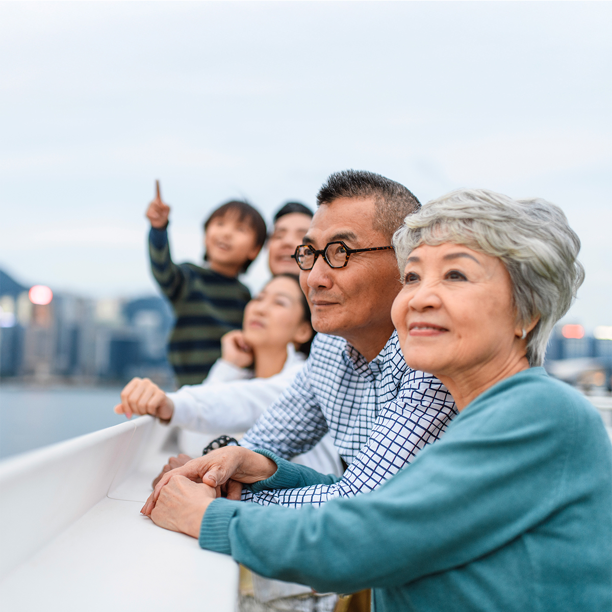 Square-format family portrait from a cruise: a woman, a boy, and relatives pose neutrally for a professional boating photo.