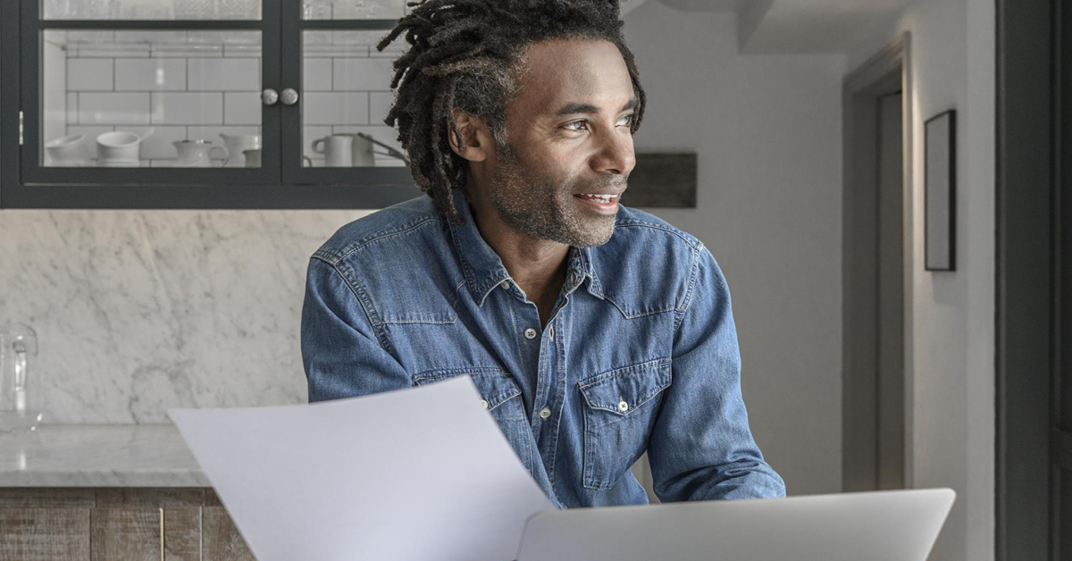 Man looking beyond computer screen